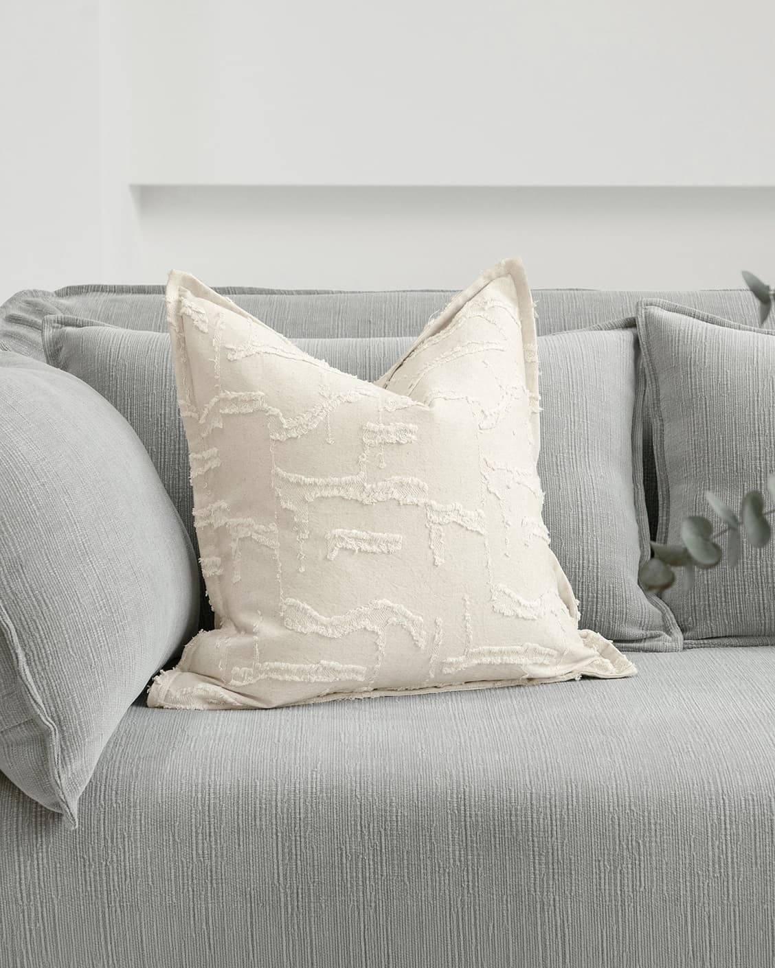Heeth Laurent cushion in cream and ivory, shown in a lifestyle front view as image 2