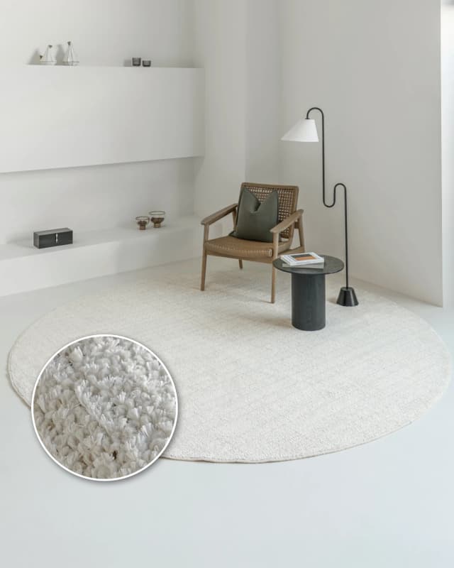 Henry Bianca Round carpet in ivory and pearl, shown in a lifestyle front view