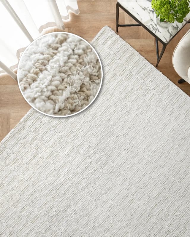 Henry Dune carpet in beige, shown in a lifestyle top view as image 2