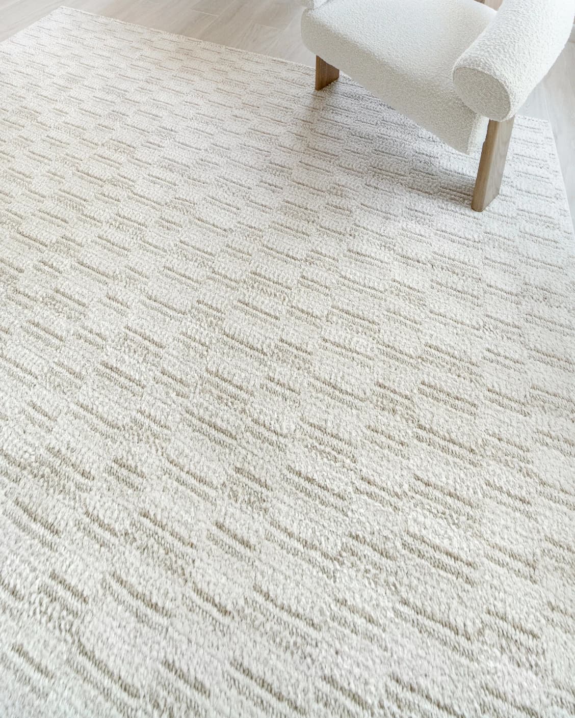 Henry Dune carpet in beige, shown in a lifestyle top view as image 10