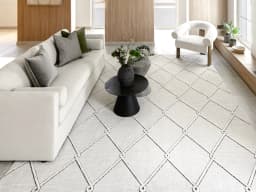 Henry Dusty carpet in ivory and charcoal, shown in a lifestyle front view