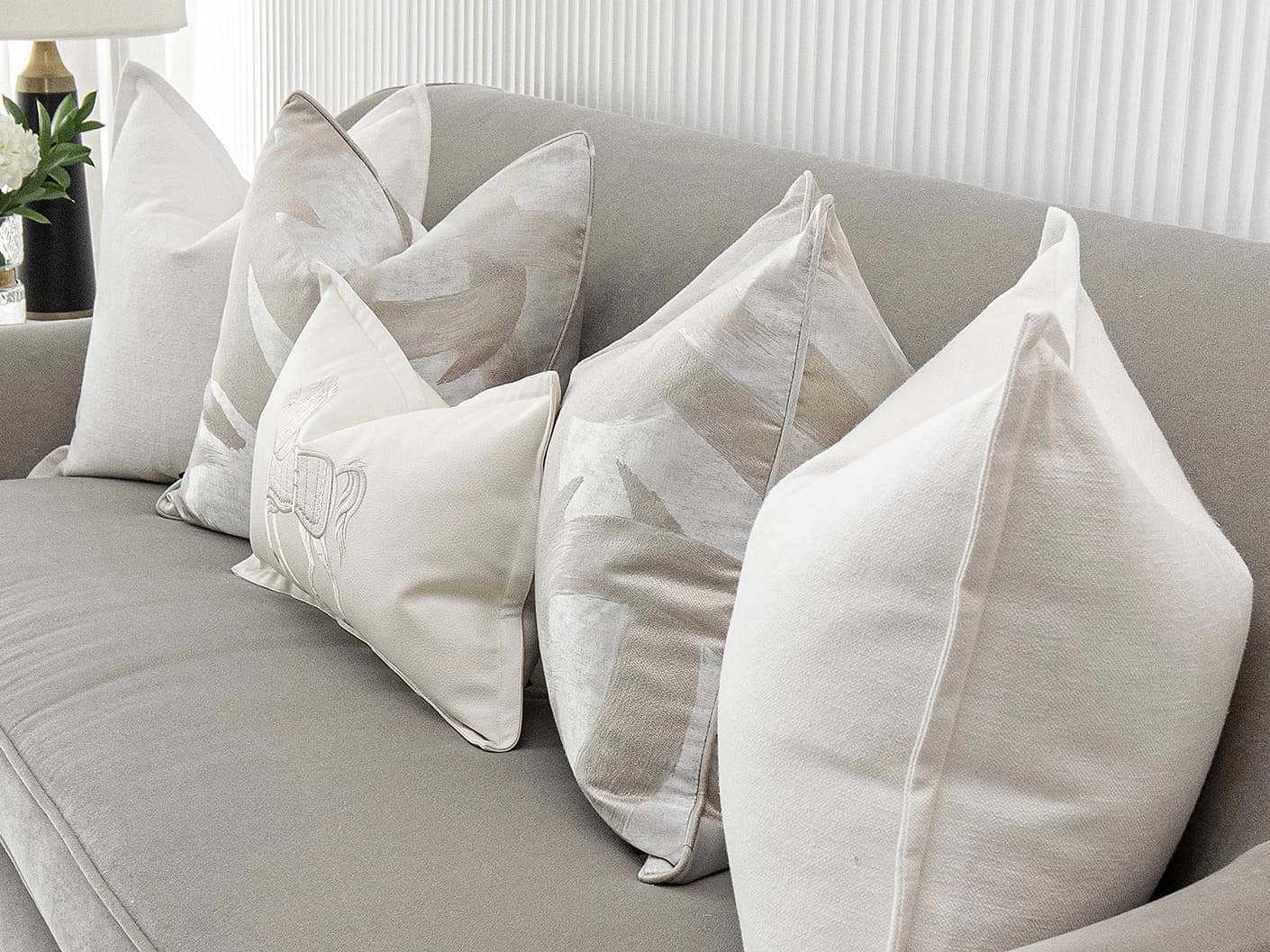 Honey Bundle bundle cushions in white, shown in a lifestyle front view