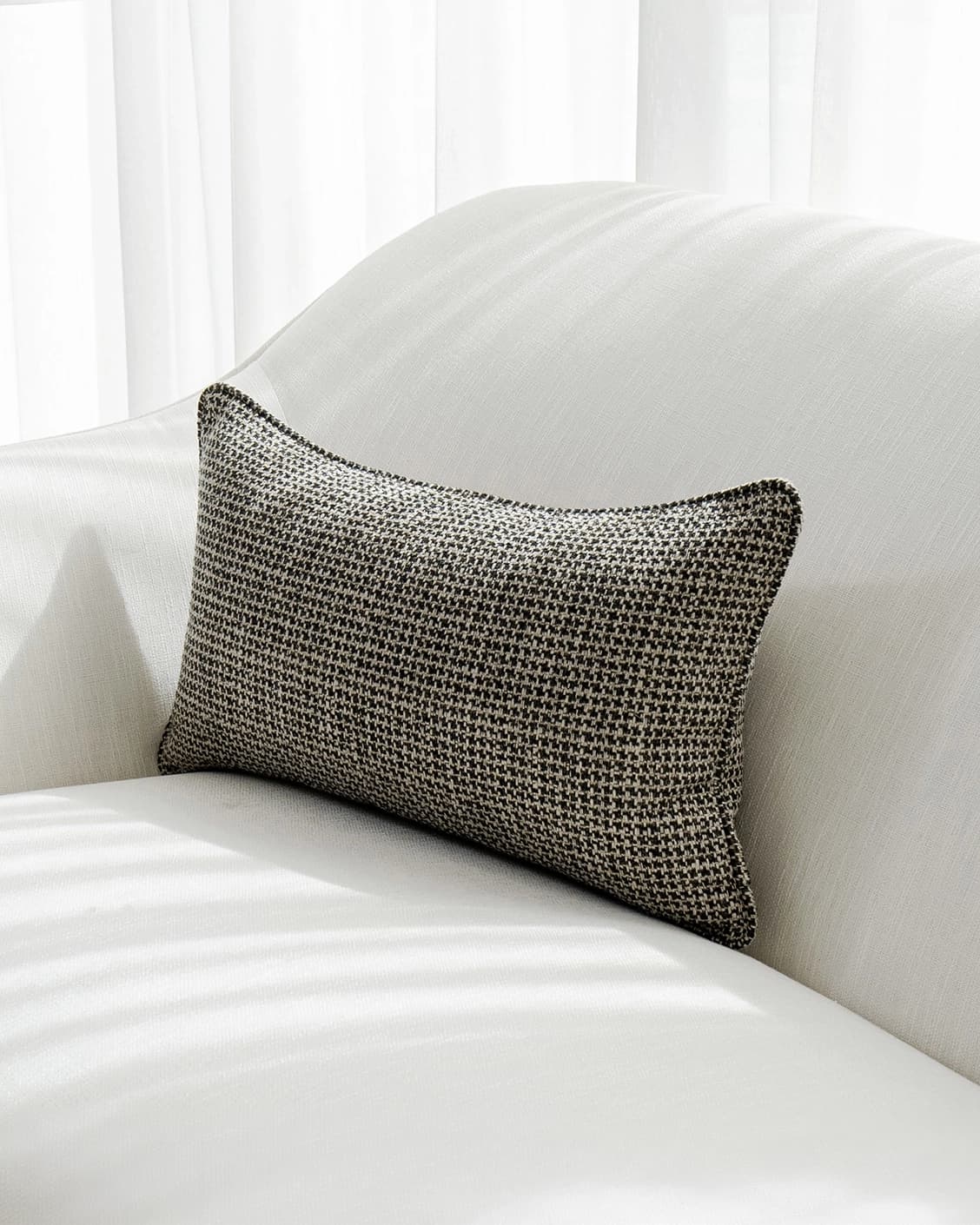 Hugo Steele II cushion in black, shown in a lifestyle front view as image 2