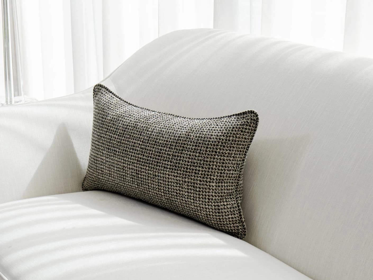 Hugo Steele II single cushions in black, shown in a lifestyle front view