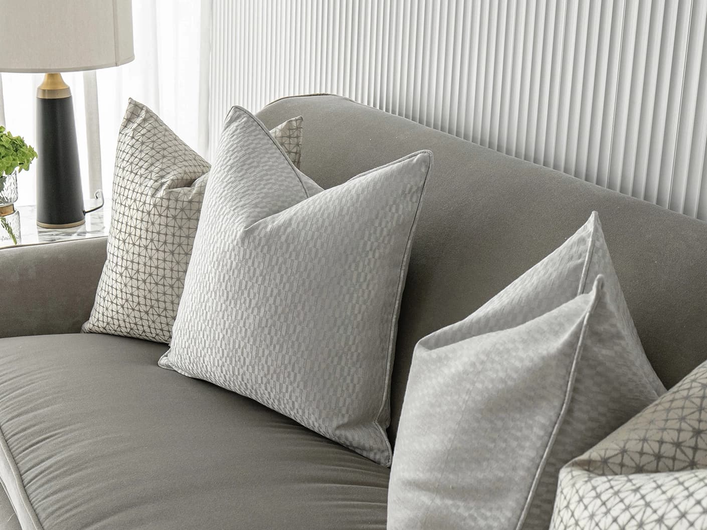 Isabelle Bundle bundle cushions in silver and white, shown in a lifestyle front view