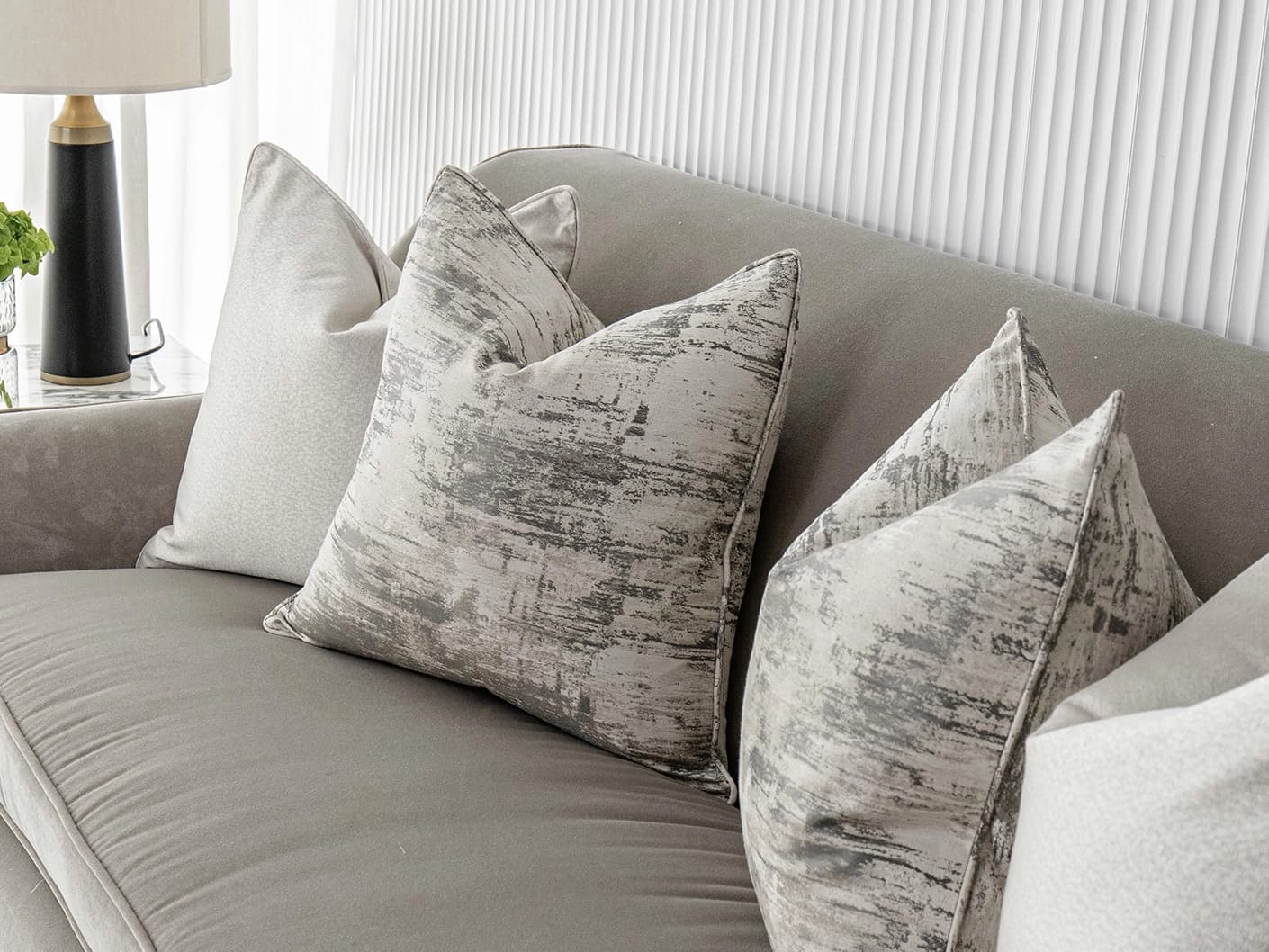 Ivanna Bundle bundle cushions in silver, grey and white, shown in a lifestyle front view