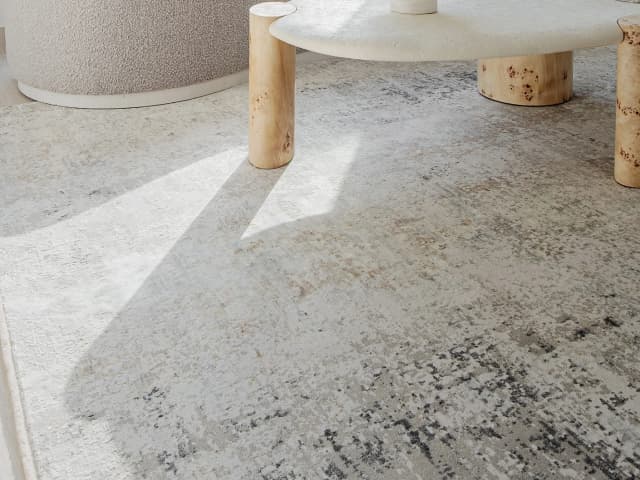 Jacob Ashton carpets in grey, silver and white, shown in a lifestyle close-up top view as image 1