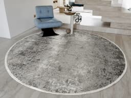 Jacob Ashton Round carpet in grey, silver and white, shown in a lifestyle front view