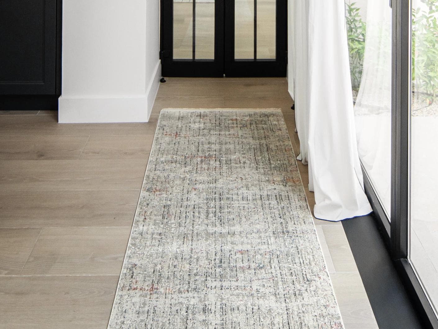 Jacob Sandy carpets in rust and grey, shown in a lifestyle front view as image 1
