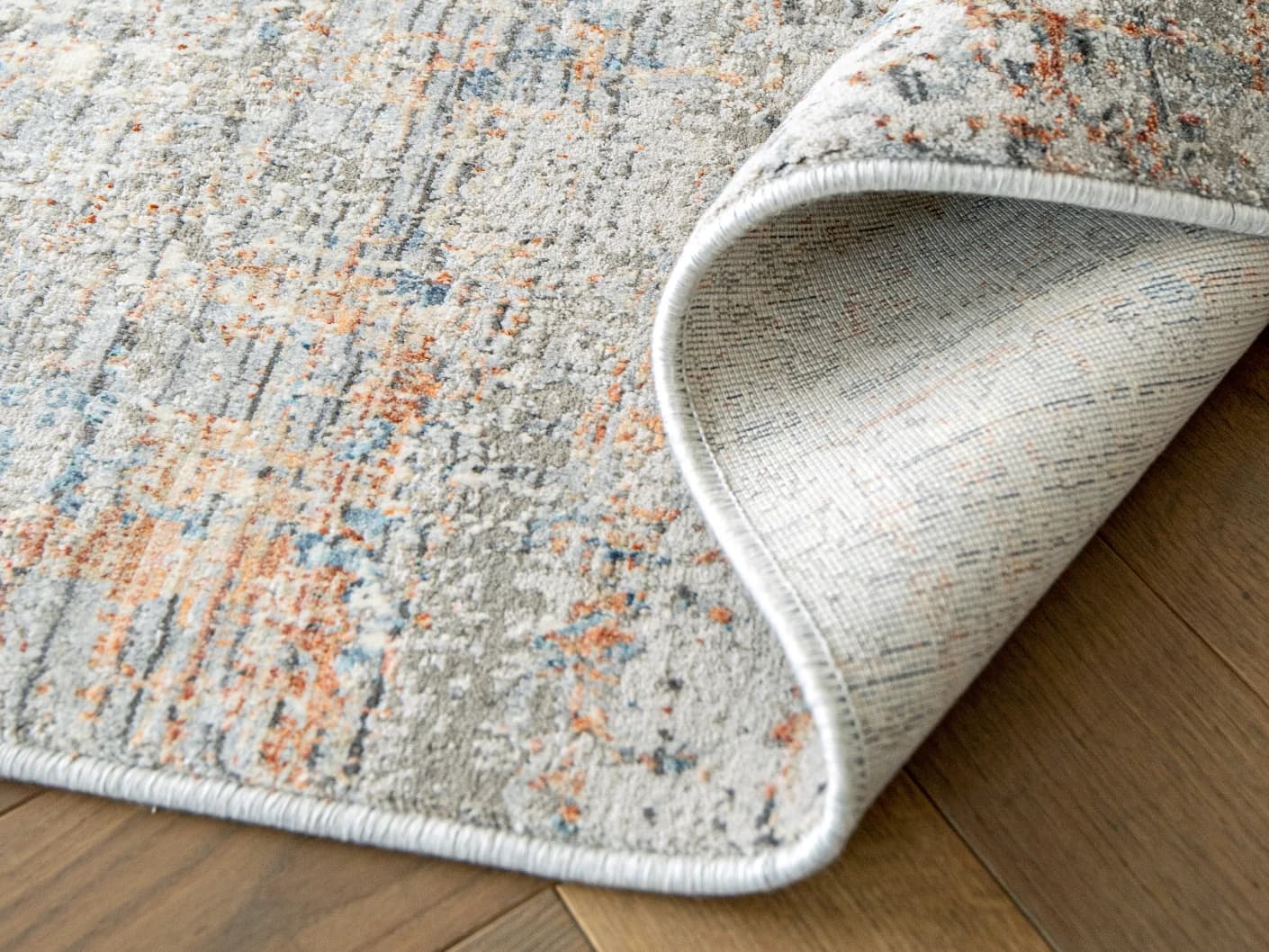 Jacob Sandy carpets in sandy, rust and grey, shown in a product close-up view