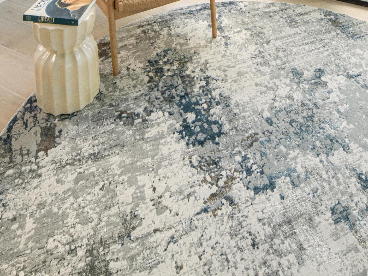 Jacob Sky Round carpet in blue and grey, shown in a lifestyle top view as image 4