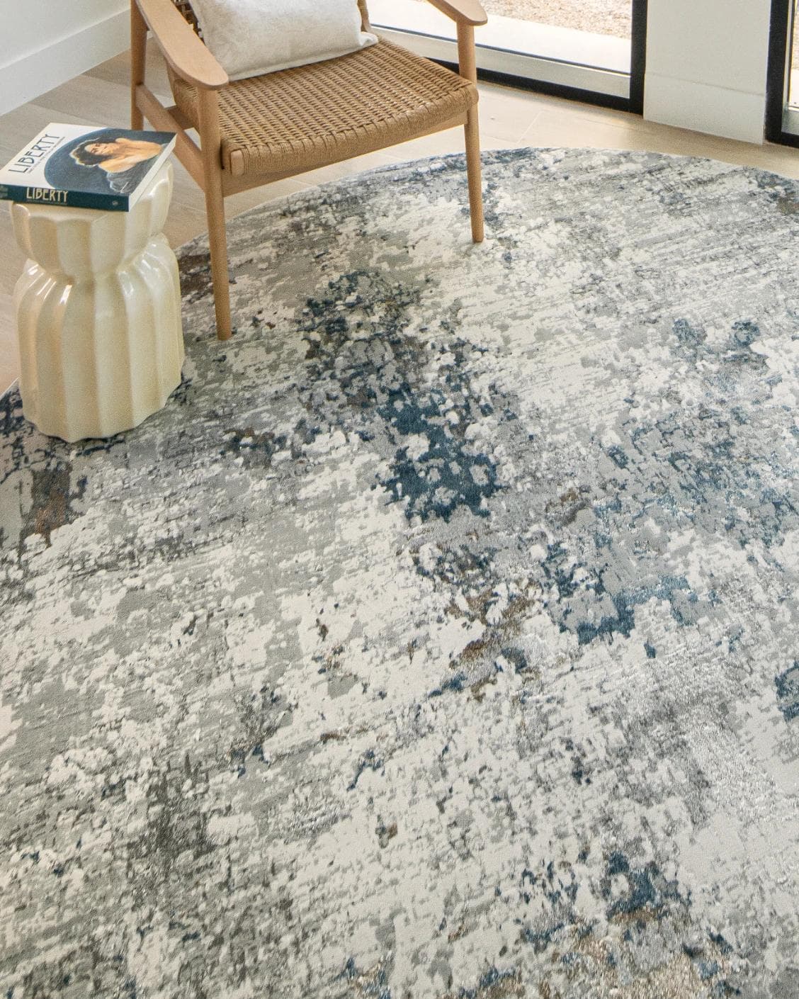 Jacob Sky Round carpet in blue and grey, shown in a lifestyle top view as image 4