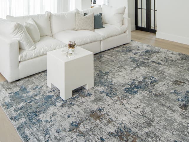 Jacob Sky Round carpet in blue and grey, shown in a lifestyle top view as image 4