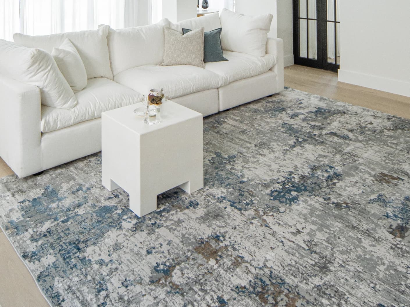 Jacob Sky Round carpet in blue and grey, shown in a lifestyle top view as image 4