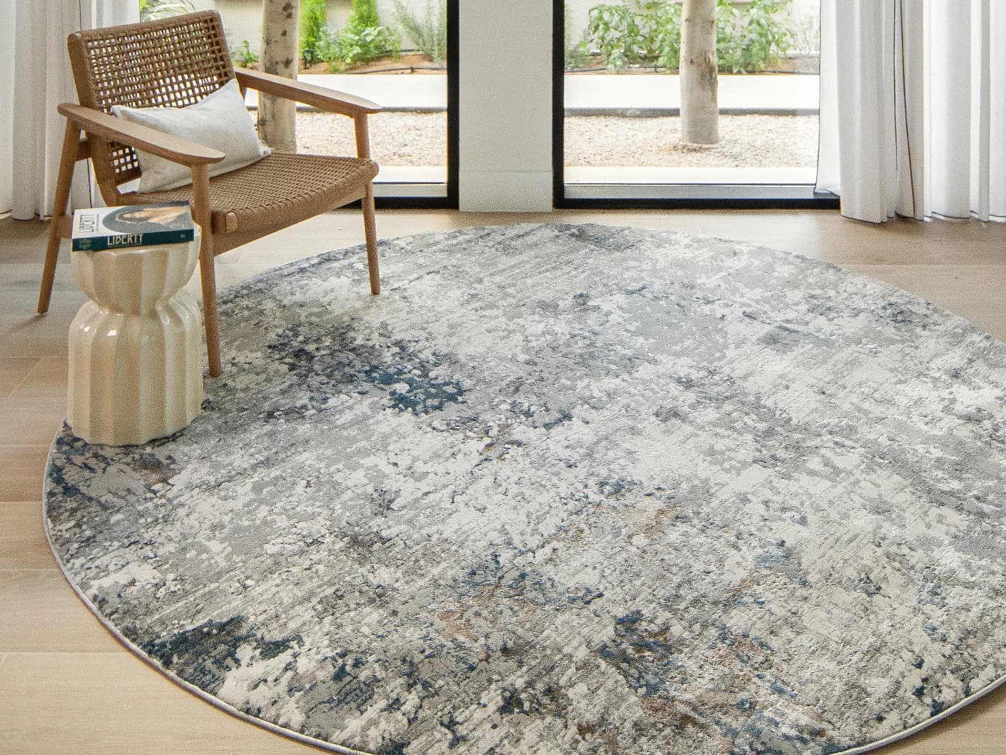 Jacob Sky Round carpet in blue and grey, shown in a lifestyle front view