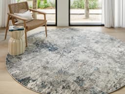 Jacob Sky Round carpet in blue and grey, shown in a lifestyle front view