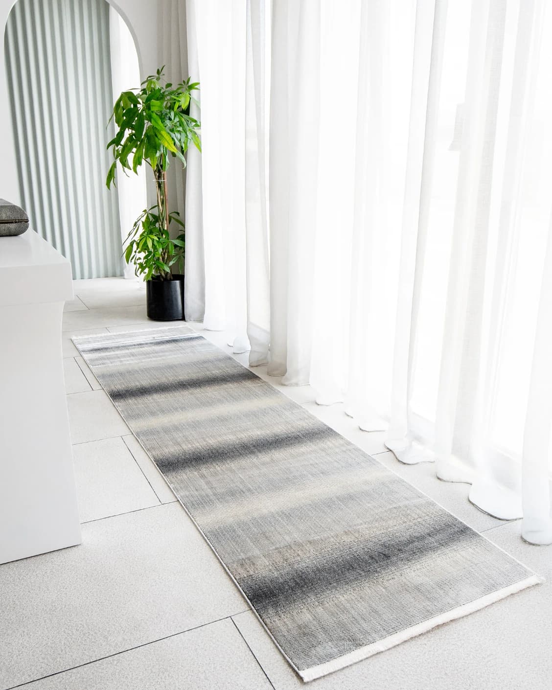 Jade Ashton Runners carpet in grey, shown in a lifestyle left view as image 2