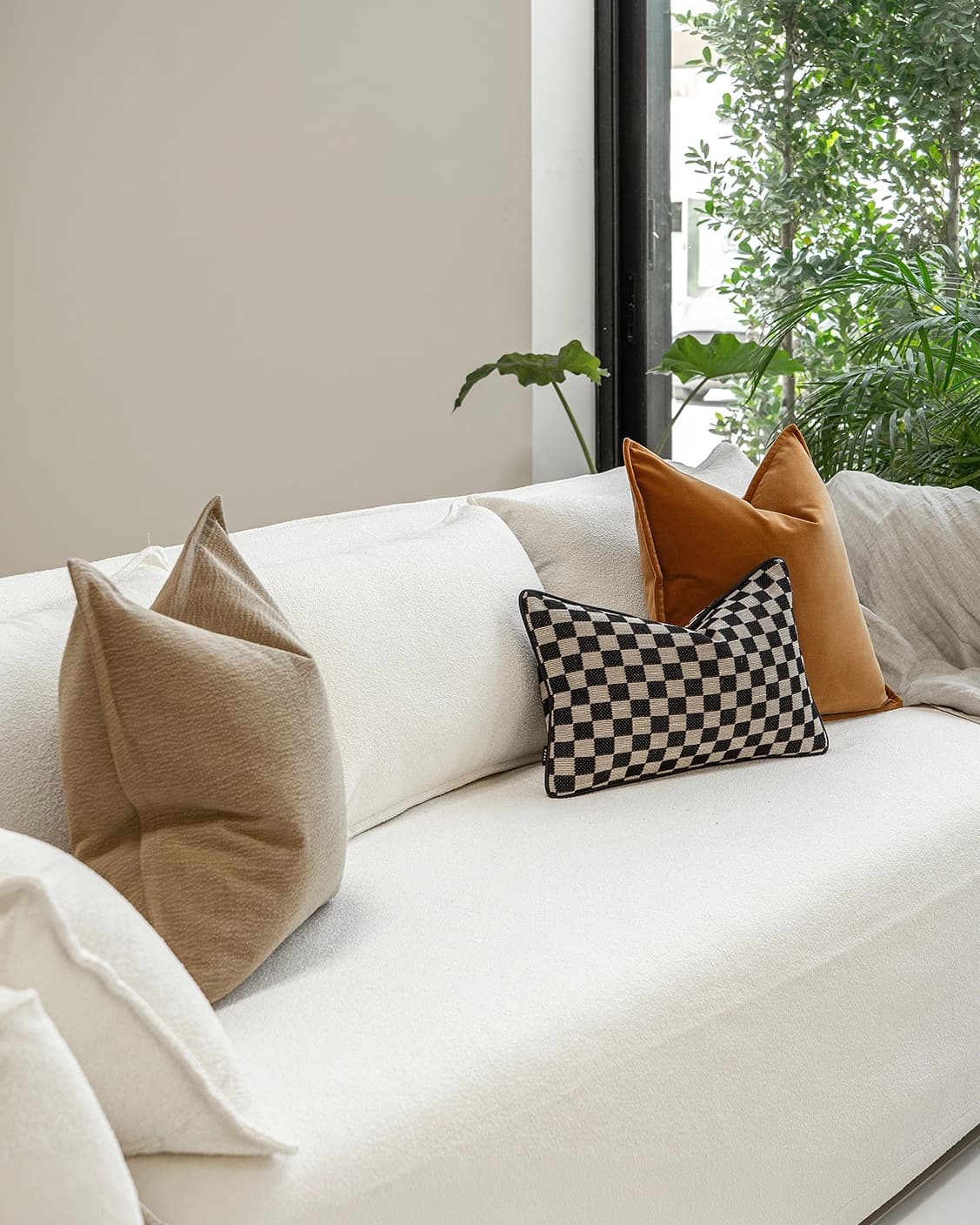 Jancil Bundle cushion in black and orange, shown in a lifestyle left view as image 2