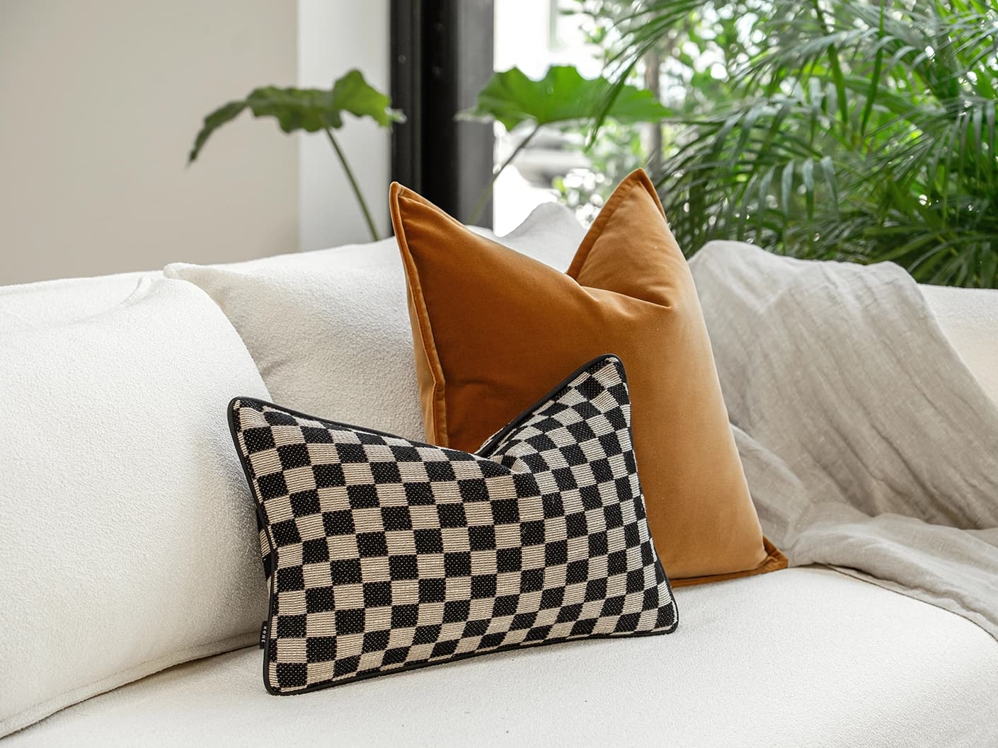 Jancil Bundle bundle cushions in black and orange, shown in a lifestyle front view