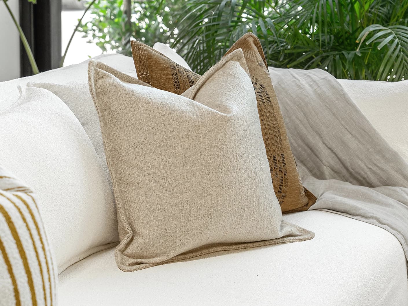 Janina Bundle bundle cushions in beige and cream, shown in a lifestyle front view