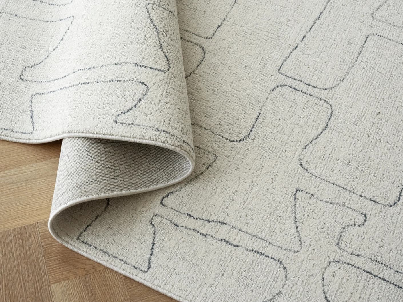 Jaxon Bianca carpets in ivory and charcoal, shown in a lifestyle close-up view