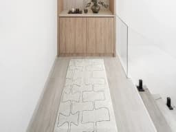 Jaxon Bianca Runners carpet in ivory and charcoal, shown in a lifestyle front view