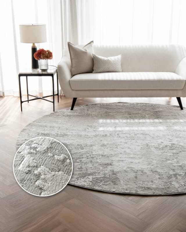 Jay Ashton Round carpet in grey, shown in a lifestyle front view
