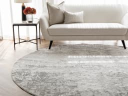 Jay Ashton Round carpet in grey, shown in a lifestyle front view