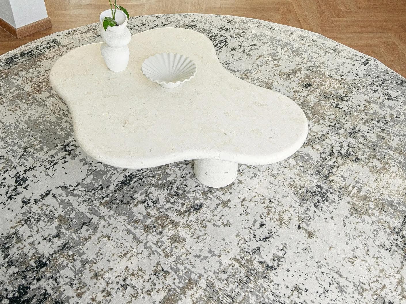 Jay Haywoods Round carpet in grey, shown in a lifestyle top view as image 4