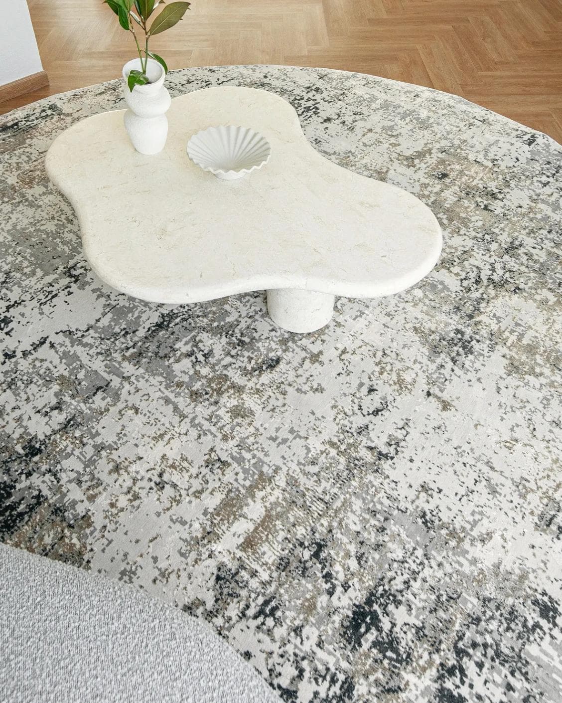 Jay Haywoods Round carpet in grey, shown in a lifestyle top view as image 4