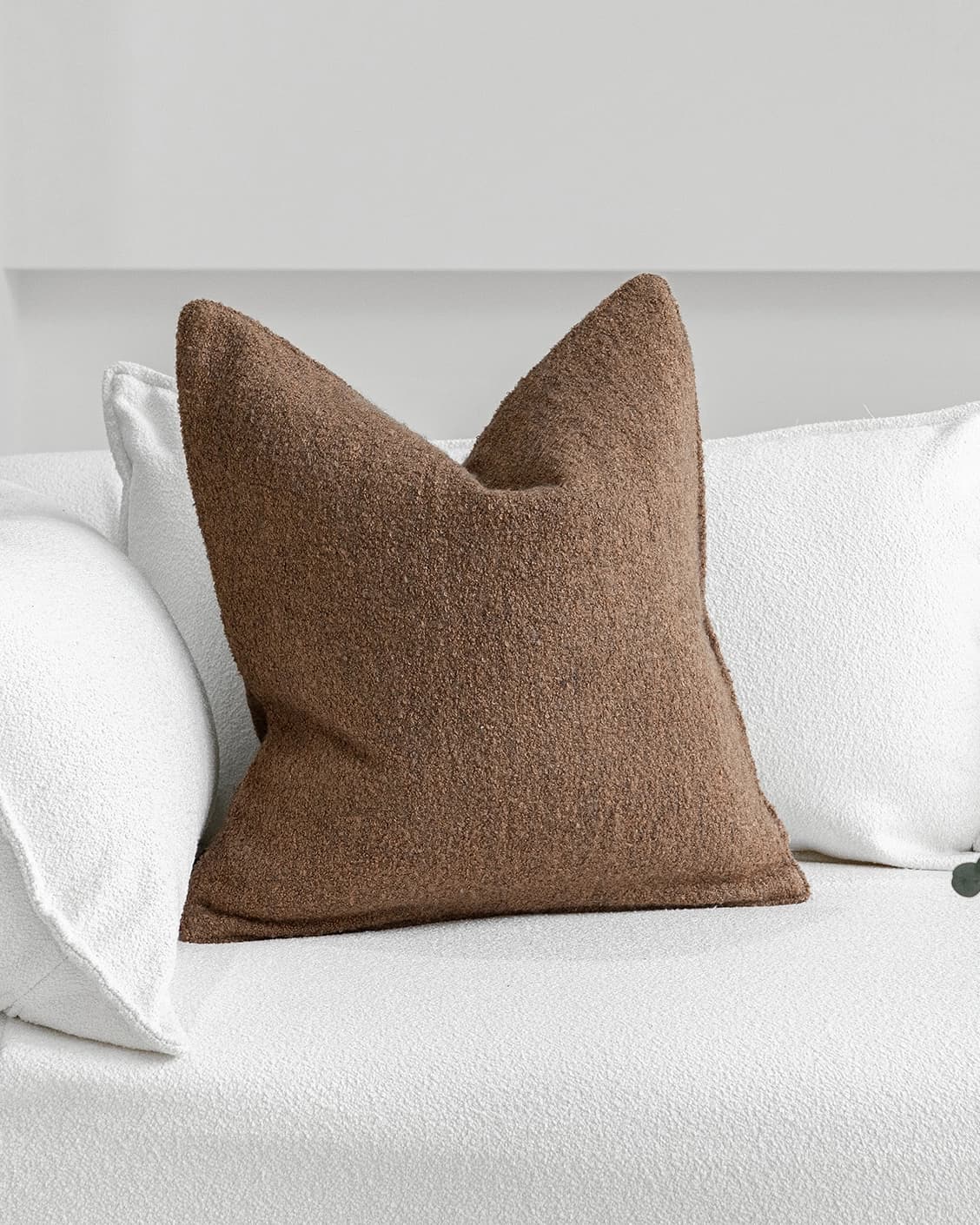 Jen Braun cushion in brown, shown in a lifestyle front view as image 2