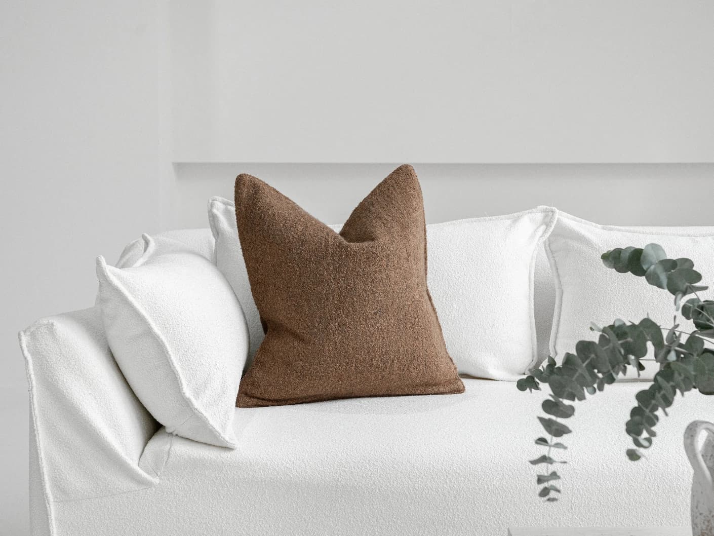 Jen Braun single cushions in brown, shown in a lifestyle front view