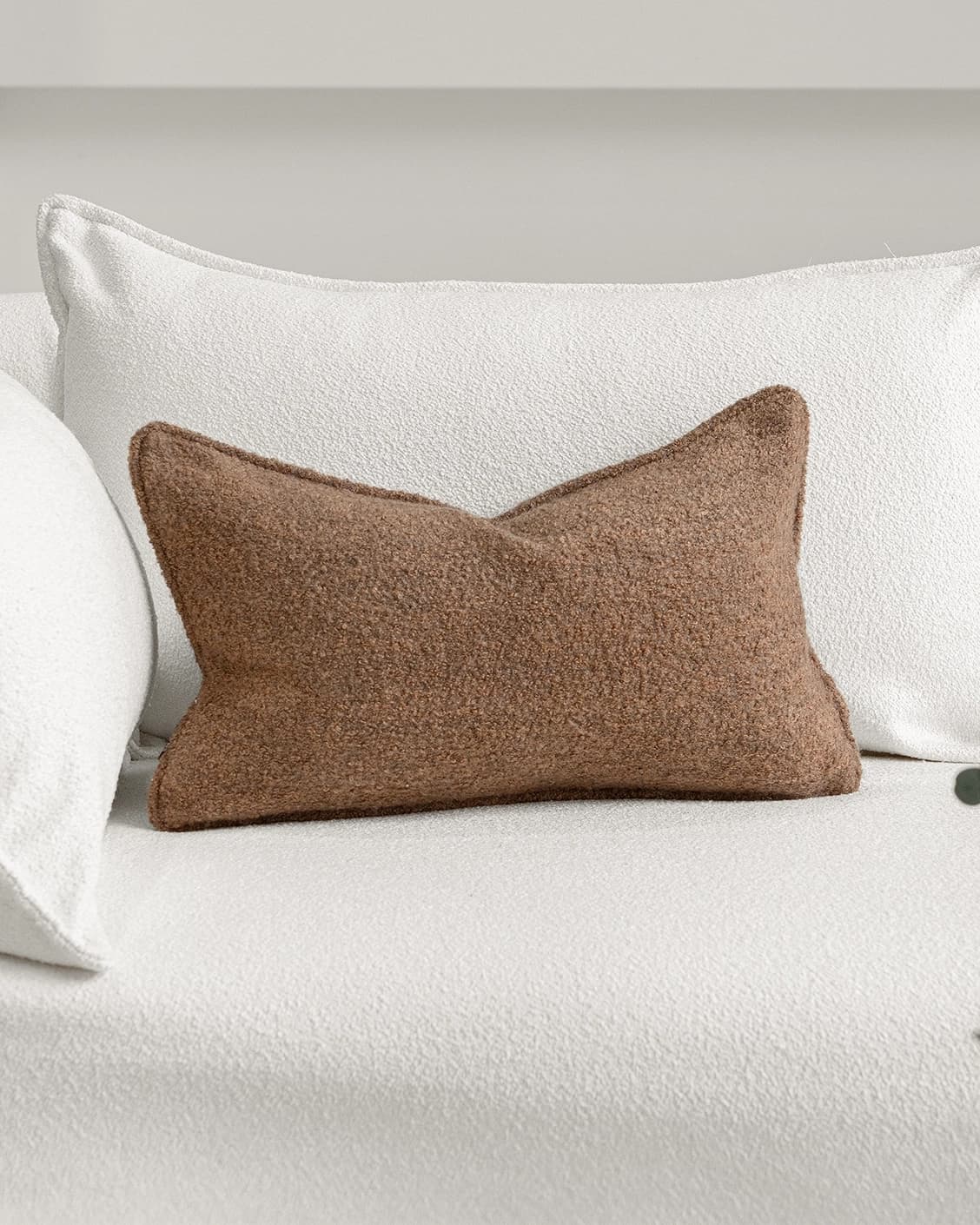 Jen Braun II cushion in brown, shown in a lifestyle front view as image 2