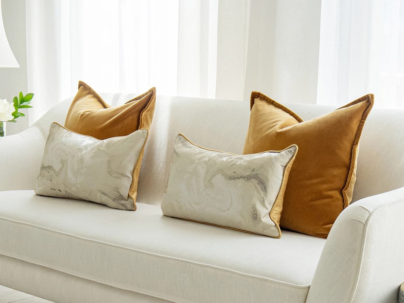 Johan Bundle bundle cushions in orange, silver and yellow, shown in a lifestyle front view