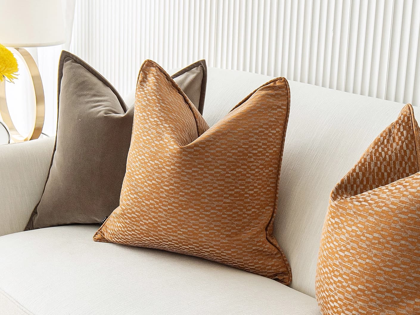 Jora Bundle bundle cushions in brown and orange, shown in a lifestyle front view
