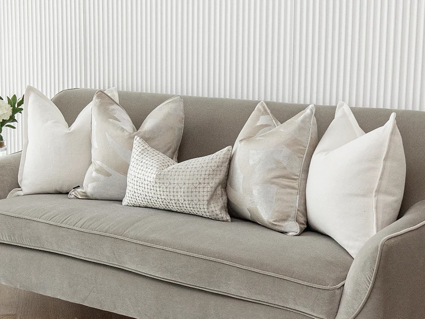 Jose Bundle bundle cushions in white, silver and beige, shown in a lifestyle front view