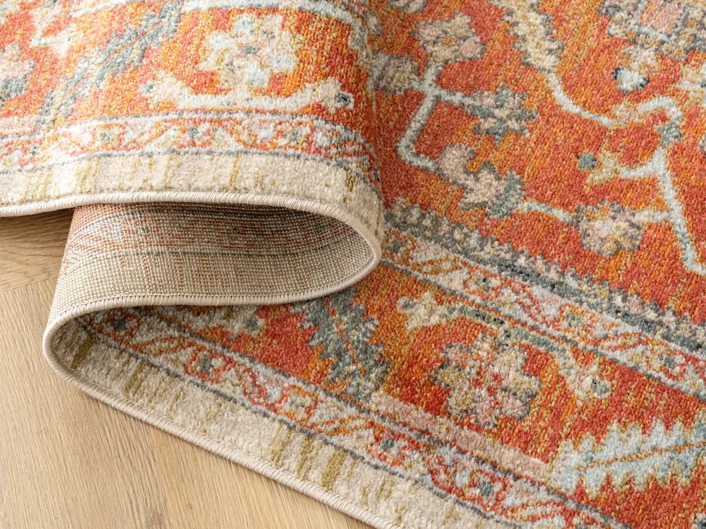 Julian Copper carpets in red and beige, shown in a product close-up view