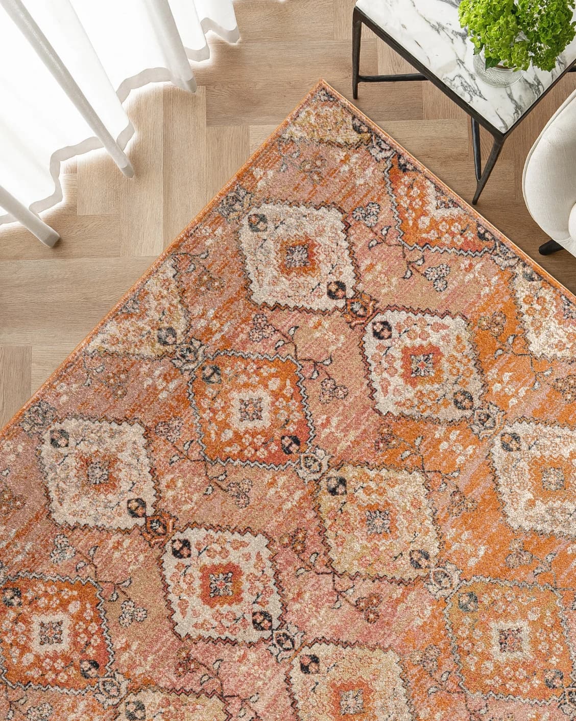 Julian Coral carpet in coral, orange and rust, shown in a lifestyle top view as image 2