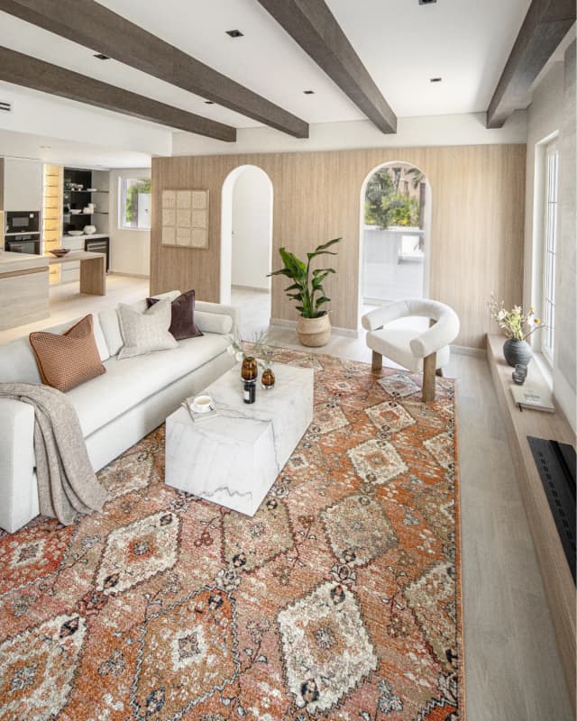 Julian Coral carpet in coral, orange and rust, shown in a lifestyle left view as image 6