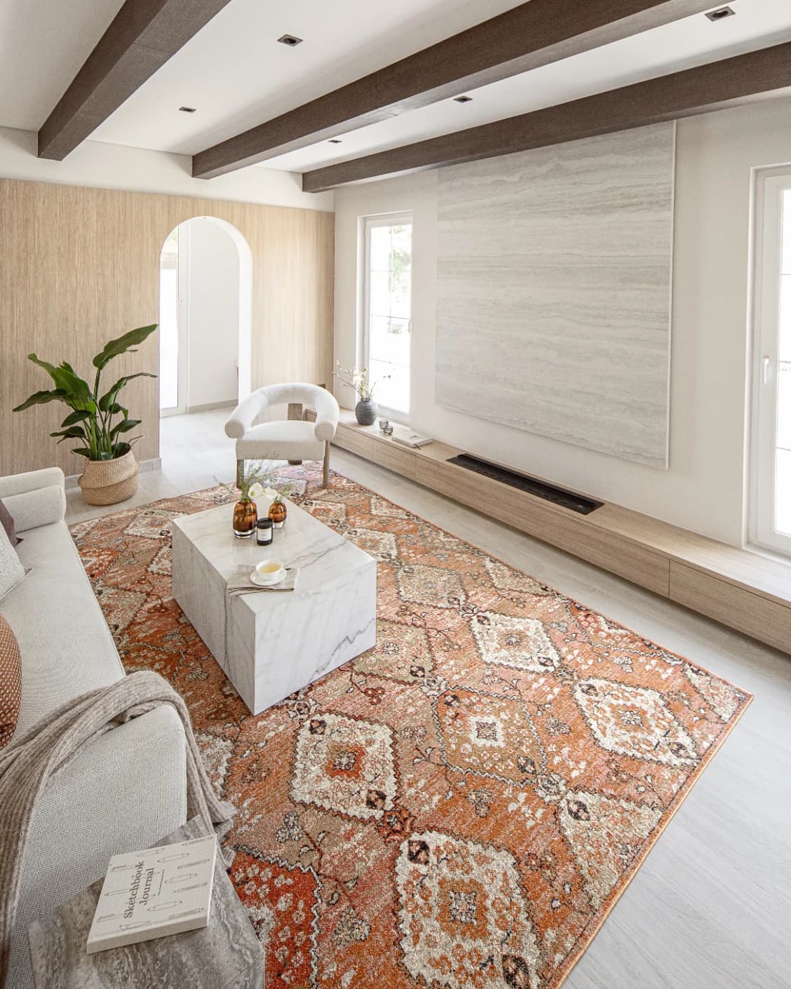 Julian Coral carpet in coral, orange and rust, shown in a lifestyle left view as image 4