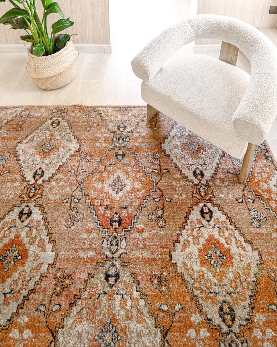 Julian Coral carpet in coral, orange and rust, shown in a lifestyle top view as image 5
