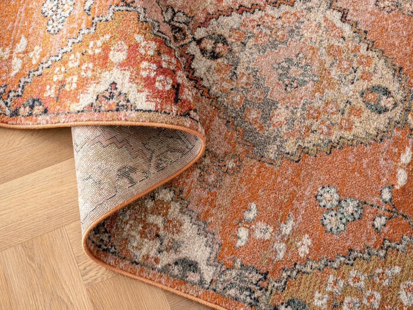 Julian Coral carpets in orange and rust, shown in a product close-up as image 1