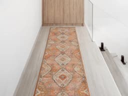 Julian Coral Runners carpet in orange and rust, shown in a lifestyle front view
