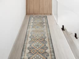 Julian Navy Runners carpet in beige, blue and multicolour, shown in a lifestyle front view