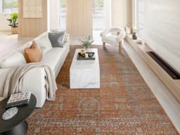 Julian Rust carpet in rust and orange, shown in a lifestyle front view