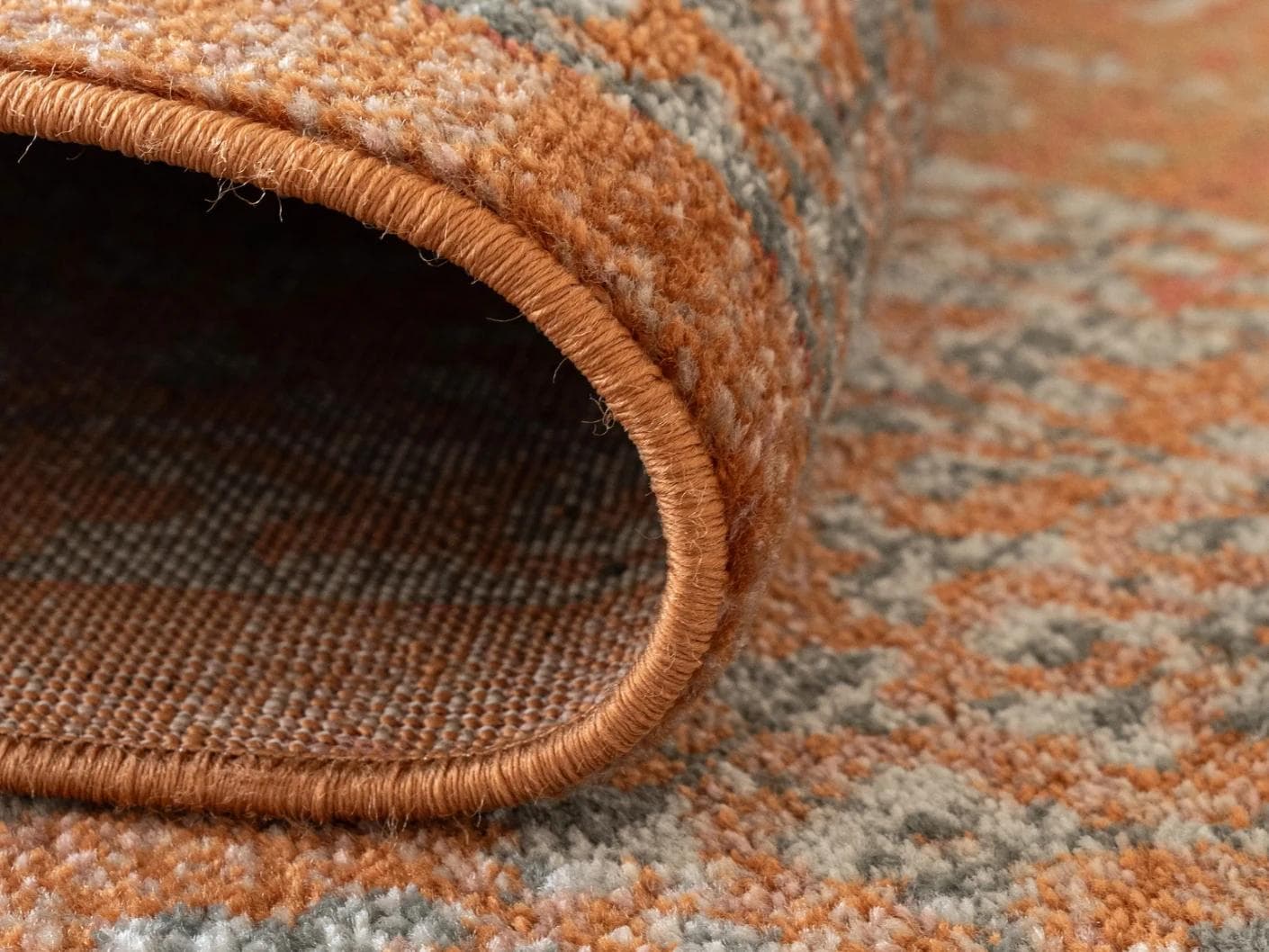 Julian Rust carpets in orange, shown in a product close-up as image 2