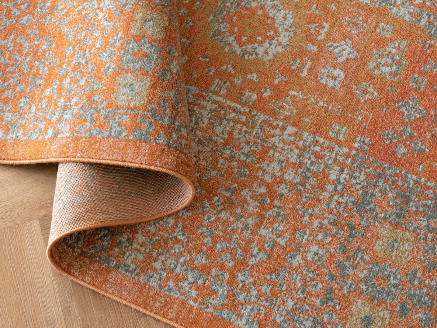 Julian Rust carpets in rust and orange, shown in a product top view