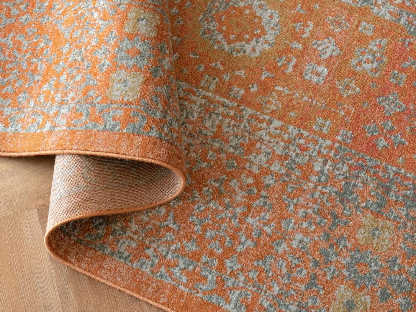 Julian Rust carpets in orange, shown in a product top view as image 1