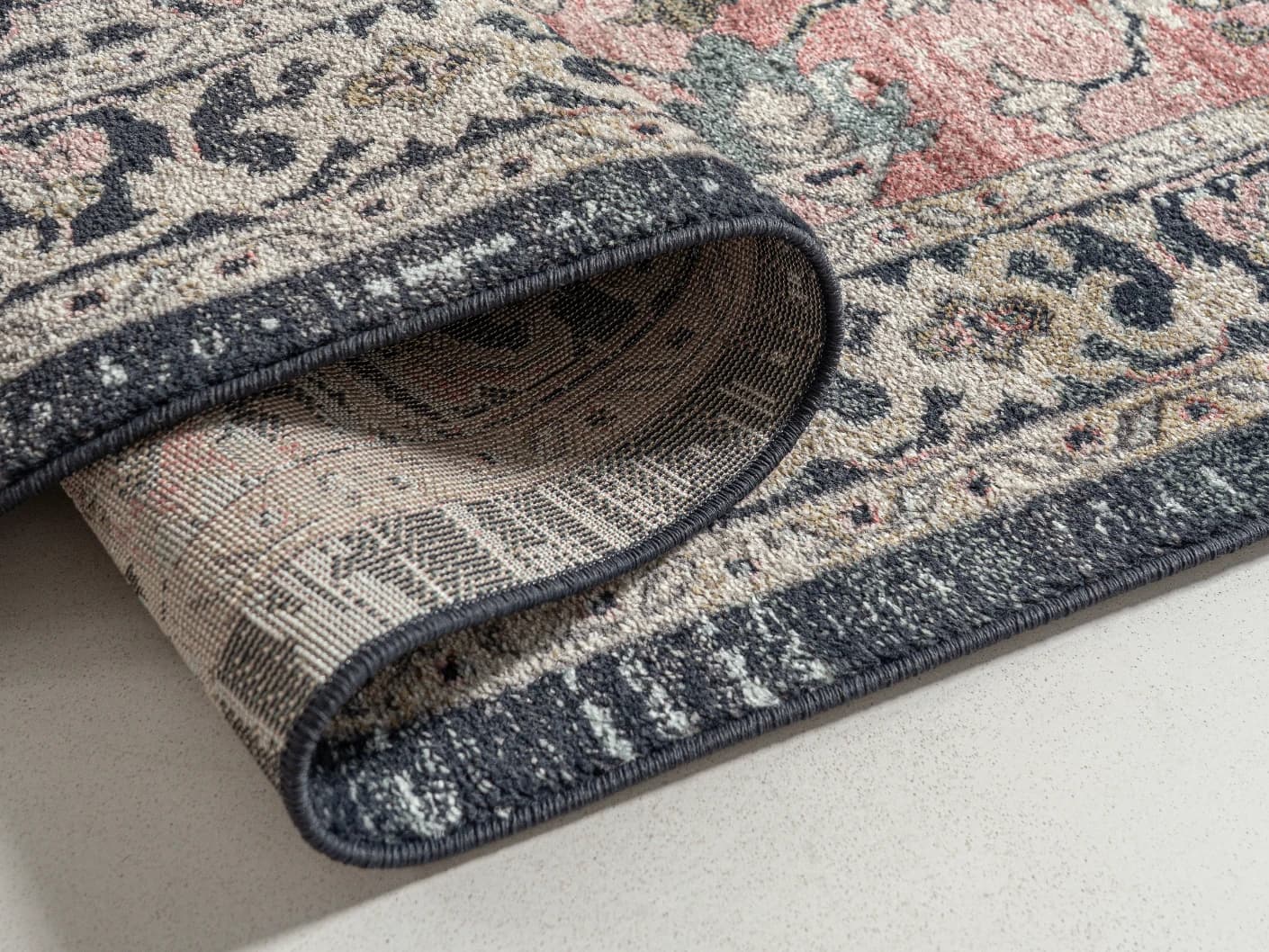 Julian Terracotta carpets in grey and pink, shown in a product close-up view