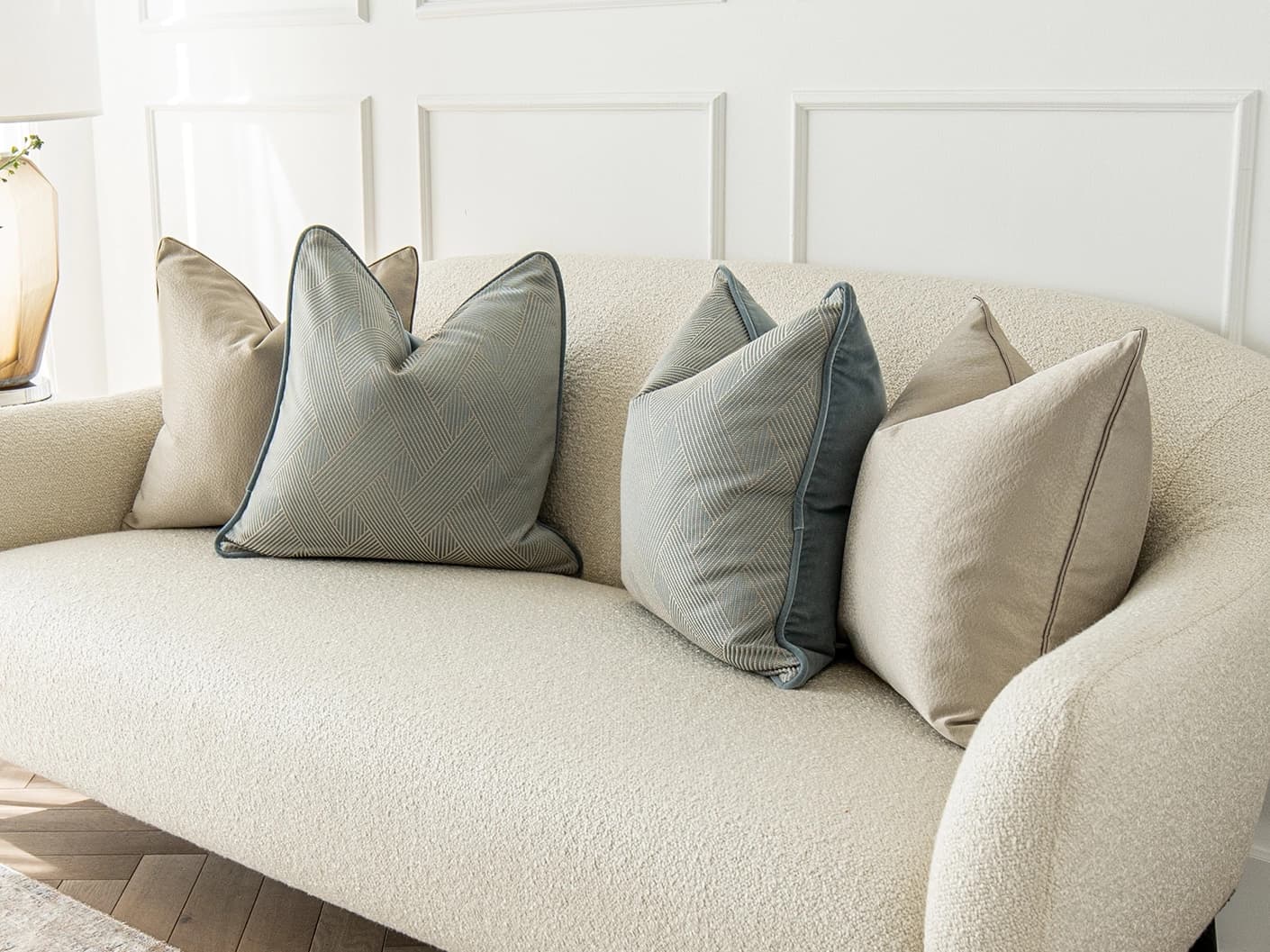 Juno Bundle bundle cushions in gold, beige and blue, shown in a lifestyle front view